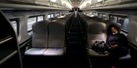 A lone passenger sleeps in an otherwise empty Amtrak train pulling into Penn Station on 9 April 2020 in Baltimore, Maryland. (Photo: Rob Carr / Getty Images)