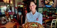 Red Rooster chef and co-owner Denise Schuil with her artisanal breakfast pizza. Inset: A Durban chicken curry order. (Photos: Wanda Hennig)<br>