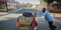 A fruit and veg mobile street vendor pushes his trolley up Vilakazi Street in search of customers.<br>(Photo: Shiraaz Mohamed)