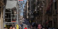 Tourists walk down a street lined with residential apartments in the Gothic district of Barcelona, Spain on Friday, March 22, 2024. In Barcelona's designated stressed residential market areas, new tenants are now entitled to a rent level no higher than the last lease agreement from the previous five years. Photographer: Manaure Quintero/Bloomberg via Getty Images
