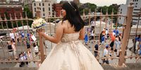 NEW YORK, NY - JUNE 11: A girl in a dress watches as people march across the Brooklyn Bridge to protest against gun violence in the March for Our Lives march and rally on June 11, 2022 in New York City. Across the country in various cities, thousands are gathering to demand for meaningful gun laws following the recent shootings from Uvalde, Texas, to Buffalo, New York. The March For Our Lives movement was spurred by the shooting at Marjory Stoneman Douglas High School in Parkland, Florida, in 2018. (Photo by Spencer Platt/Getty Images)