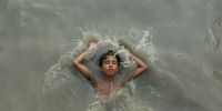 A Pakistani boy cools off at a canal in Peshawar, Pakistan, 29 July 2025. Temperatures rose to up to 39 degrees Celsius in Peshawar.  EPA/BILAWAL ARBAB
