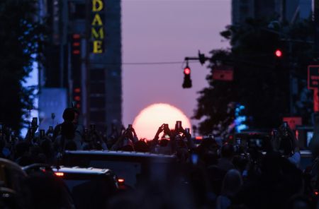 The sun aligns between buildings in New York City, and more from around the world