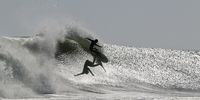 Surfer with his dancing shadow. Photographer: Toya Louw