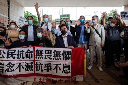 Hong Kong's veteran pro-democracy activists defiant as they hear charges in court