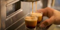 Coffee pours from a coffee machine into espresso glasses at a Starbucks coffee shop in London. (Photo: Jason Alden / Bloomberg via Getty Images)