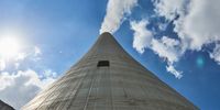 Vapour rises from a chimney at the Eskom Holdings SOC Ltd. Tutuka coal-fired power station in Mpumalanga, South Africa, on Thursday, Nov. 18, 2021. South Africa's energy department has said it will start preparing for the end of coal-for-power use in the country but cautioned that a retreat from the dirtiest fossil fuel must take account of the impact on the economy and the people who depend on it for a living. Photographer: Waldo Swiegers/Bloomberg via Getty Images
