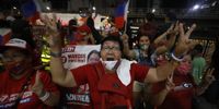 Supporters of presidential candidate Ferdinand  ‘Bongbong’ Marcos Junior cheer outside his campaign headquarters in Mandaluyong City, Metro Manila, Philippines on 9 May 2022.  (EPA-EFE / Francis R Malasig)