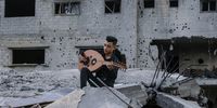 A Palestinian student of the Edward Said National Conservatory of Music plays an oud guitar during a musical event near the rubble of destroyed buildings following Israeli airstrikes, in Deir Al-Balah town, central Gaza Strip, 16 May 2023. Israel and Islamic Jihad movement agreed to an Egyptian-brokered truce late on 13 May. Israel has carried out several attacks against the military leadership of the Palestinian Islamic Jihad movement, in retaliation to rockets being fired towards Israel from the Gaza Strip.  EPA-EFE/MOHAMMED SABER
