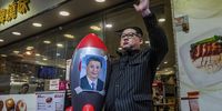 An impersonator of North Korean leader Kim Jong Un waves while holding an inflatable rocket with picture of Chinese President Xi Jinping during a protest in Hong Kong on 1 July 2020. Hong Kong woke up to a new reality after China began enforcing a sweeping security law that could reshape the financial hub’s character 23 years after it took control of the former British colony. (Photo: Lam Yik / Bloomberg via Getty Images)