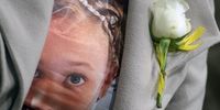 During sentencing proceedings, a family member wore a white rose and a T-shirt printed with an image of Joshlin Smith. (Photo: Gallo Images / Brenton Geach)