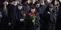 Romanian Orthodox nuns hold flowers while marching in front of the relics of Saint Dimitrie Basarabov (Saint Demetrius the New), the patron saint of Romania's capital, during a procession around Patriarchal Cathedral in Bucharest, Romania, 24 October 2024. Romanians will celebrate Saint Dimitrie Basarabov on 27 October, with thousands of pilgrims from all over the country expected in Bucharest to worship the relics of the patron saint of Bucharest.  EPA-EFE/ROBERT GHEMENT