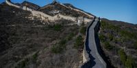 A Chinese boy wears a protective mask as he walks on a nearly empty section of the Great Wall on March 27, 2020 near Badaling in Beijing, China. A limited section of the iconic tourist site was re-opened to the public this week allowing a smaller number of visitors to reserve tickets online in advance and to enter after passing health screening. With the pandemic hitting hard across the world, China recorded its first day with no new domestic cases of the coronavirus last week, since the government imposed sweeping measures to keep the disease from spreading.  For two months, millions of people across China have been restricted in how they move from their homes, while other cities have been locked down in ways that appeared severe at the time but are now being replicated in other countries trying to contain the virus. Officials believe the worst appears to be over in China, though there are concerns of another wave of infections as the government attempts to reboot the worlds second largest economy.  In Beijing, it is mandatory to wear masks outdoors, retail stores operate on reduced hours, restaurants employ social distancing among patrons, and tourist attractions at risk of drawing large crowds remain closed.  Monitoring and enforcement of virus-related measures and the quarantine of anyone arriving to Beijing is carried out by neighborhood committees and a network of Communist Party volunteers who wear red arm bands.  A primary concern for Chinese authorities remains the arrival of flights from Europe and elsewhere, given the exposure of passengers in regions now regarded as hotbeds for transmission. Since January, China has recorded more than 81,000 cases of COVID-19 and at least 3200 deaths, mostly in and around the city of Wuhan, in central Hubei province, where the outbreak first started. (Photo by Kevin Frayer/Getty Images)