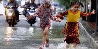 Childrens play in the waterlogged streets following heavy rain in Bangalore, India, 21 October 2024. India Meteorological Department (IMD), weather department issued an orange alert amid intermittent rain. Due to heavy rains in Bangalore, schools are shut down today, and private offices have asked their employees to work from home, and several trees are uprooted. This comes owing to a well-marked low-pressure area over central parts of the south Bay of Bengal.   EPA-EFE/JAGADEESH NV Coverage code 66012
