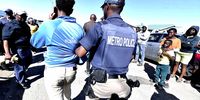 A policeman arrests a spaza shop owner for allegedly violating municipal regulations  in Kwazakhele, Gqeberha on 11 November 2024. This after reported food poisoning incidents cost the lives of young people, allegedly from snacks bought from unregulated spaza shops. (Photo: Gallo Images / Die Burger / Lulama Zenzile)