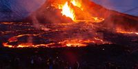 REYKJANES PENINSULA, ICELAND - MARCH 28: People's figures are illuminated by the glow of the lava on March 28, 2021 on the Reykjanes Peninsula, Iceland. The Mount Fagradalsfjall volcano erupted on March 19, after thousands of small earthquakes in the area over the recent weeks, and was reportedly the first eruption of its kind on the Reykjanes Peninsula in around 800 years. (Photo by Sophia Groves/Getty Images)