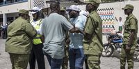 Tanzanian police officers detain a man (C) accused by electoral officials of attempting to taint the voting process at a polling station in Stone Town on October 29, 2025, during Tanzanias presidential elections. Polls opened on October 29, 2025 in Tanzania elections in which the main challengers were either jailed or barred from running, with rights groups decrying a "wave of terror".<br>President Samia Suluhu Hassan, 65, is determined to cement her position with an emphatic victory that will silence critics within her own party, analysts say. (Photo by MARCO LONGARI / AFP)