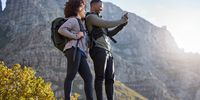 Camera, fitness and couple hiking, view and exercise for wellness, health and cardio with happiness. Training, black man and woman with workout, picture and memory with a smile, hike and adventure.