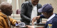 Police officers take Siphesihle Tatsi's (23) fingerprints after he was sentenced to 18 years in prison at Mthatha High Court, Eastern Cape on 25 July 2023. (Photo: Hoseya Jubase)