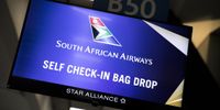 A sign hangs above the South African Airlines (SAA) bag-drop area inside O.R. Tambo International Airport in Johannesburg, South Africa, on Friday, Feb. 28, 2020. (Photo: Guillem Sartorio/Bloomberg via Getty Images)