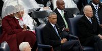 WASHINGTON, DC - JANUARY 20: Former president Barack Obama and former Vice President Joe Biden listen to the inaugural proceedings as Michelle Obama and Dr. Jill Biden sit under an umbrella on the West Front of the U.S. Capitol on January 20, 2017 in Washington, DC. In today's inauguration ceremony Donald J. Trump becomes the 45th president of the United States.  (Photo by Joe Raedle/Getty Images)