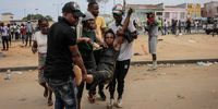 epa10320303 People help an injured woman after the police used tear gas to disperse a riot in the surroundings of the city's Santa Ana cemetery, where the kuduro musician known as 'Nagrelha' was to be buried, near Luanda, Angola, 22 November 2022. Gelson Caio Manuel Mendes, better known as 'Nagrelha', the most famous singer in the kuduro musical style, died in Luanda, of lung cancer, according to the Complexo Hospitalar de Doencas Cardiovasculares Dom Alexandre do Nascimento, where he was being cared for. He was 36.  EPA-EFE/AMPE ROGERIO PORTUGAL OUT