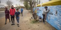 Eldorado Park teens admire the mural which took two days to complete. (Photo: Shiraaz Mohamed)