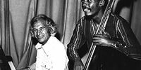 1976: From left, Dave Brubeck and bass player Victor Ntoni perform in Johannesburg. (Photograph by Ronnie Kweyi, image courtesy of NSRM)
