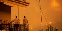 Local residents monitor the progress of wildfire in Gouves village, on the island of Evia, Greece, on Sunday, Aug. 8, 2021. Thousands of residents were evacuated from the Greek island of Evia by boat after wildfires hit Greeces second biggest island. Photographer: Konstantinos Tsakalidis/Bloomberg via Getty Images