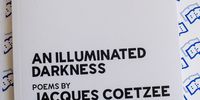 A print copy of Jacques Coetzee's Ingrid Jonker Prize winning collection of poems, 'An Illuminated Darkness'. 21 July 2022. Image: David Harrison