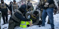 Federal law enforcement agents detain a demonstrator during a raid in south Minneapolis, Minnesota, US, on Tuesday, 13 January 2026. (Photo: Victor J. Blue / Bloomberg via Getty Images)