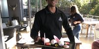 Five-star waiter Andile Ndebele does a twirl with the Flavour of Roses dessert. (Photo: Marie-Lais Emond) 
