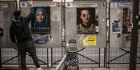 epaselect epa09874029 French street artist Jaeraymie pastes elections posters depicting caricatures of French far right candidate Marine Le Pen (L) and French President Emmanuel Macron (R) in the streets of Paris, France, 06 April 2022. Jaeraymie says he caricatures French Presidential candidates who stigmatized a social group of people with words or actions. The first round of the French presidential election will take place on 10 April and the second round on 24 April.  EPA-EFE/YOAN VALAT