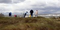 People enjoy a walk during stormy weather at Mangalsala beach in Riga neighborhood, Latvia, 08 October 2023. High, gusty winds persist in Latvia on 08 October, though they have abated slightly compared to the storm the previous days. Nevertheless, a yellow warning for high winds remains in place across the country and is upgraded to an orange warning along the coast.  EPA-EFE/TOMS KALNINS