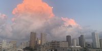 Late afternoon sun colours clouds above a Tokyo skyline as the moon makes an appearance. Image: Pete Juds