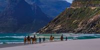 Horse riding on Noordhoek Beach, Chapman’s Peak and the Sentinel in the background. Photographer: Conrad MB Walker