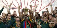 South African President Cyril Ramaphosa lifts the Webb Ellis trophy standing next to the team's captain Siya Kolisi (C right) after the team won the Rugby World Cup 2023 final between New Zealand and South Africa in Saint-Denis, France, 28 October 2023.  (Photo: EPA-EFE / YOAN VALAT)