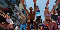 NEW YORK, NY - JUNE 21:  Simeone Scaramozzino (C) and other enthusiasts perform yoga in Times Square during an event marking the summer solstice on June 21, 2013 in New York City. Thousands of yogis will attend the free day-long event in Manhattan on the longest day of the year.  (Photo by Mario Tama/Getty Images)