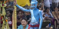 A child with his body and face painted prepares for the sacred Ngerebeg ritual at the Tegallalang village in Gianyar, Bali, Indonesia, 03 April 2024. The sacred Ngerebeg ritual takes place every six months and it is mainly aimed at driving all evil spirits out of the villages. During the ritual, the participants paint their bodies in various colors and patterns to join the procession across the village.  EPA-EFE/MADE NAGI