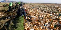 ORURO, BOLIVIA - APRIL 7: A man picks up plastic bottles during a cleaning task in the Tagarete River which flows into Uru Uru Lake on April 7, 2021 in Oruro, Bolivia. Located 200 kilometers from Bolivian Capital La Paz and over the 3,500 meters above sea level, the Uru Uru lake is polluted by plastic bottles, bags and waste of San José mine. Around 500 police officers and residents of surrounding villages gather for a cleaning plan to recover the waters of the lake and its tributaries. (Photo by Gaston Brito Miserocchi/Getty Images)