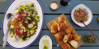 The bread keeps coming to mop up tapenade, nasturtium butter and crunchy farm salad with buffalo mozzarella. (Photo: Kit Heathcock)<br>