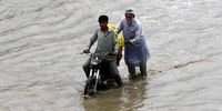 epa09445140 People make their way through a flooded road after heavy rains in Karachi, Pakistan, 03 September 2021. The Pakistan Meteorological Department (PMD) revealed that Karachi is surrounded by rain clouds, adding that a cloud mass that has developed over the ocean is moving towards the city.  EPA-EFE/SHAHZAIB AKBER