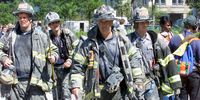 Streets of lower Manhattan with fireman, police, and rescue crews after the colapse of the World Trade Center after being hit by two airplanes on September 11, 2001.  photo by Gabe Palacio/ImageDirect