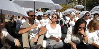 Rachel and Jon Goldberg-Polin, the parents of an Israeli-American hostage Hersh Goldberg-Polin killed in captivity, join hundreds of women dressed in white with umbrellas; mothers, sisters and family members of Israeli hostages held in by Hamas in Gaza,  block a road outside Prime Minister Benjamin Netanyahu's residence during a quiet protest calling for the release of hostages, in Jerusalem, 20 November 2024. According to the Israeli army (IDF) spokesperson, around 100 Israeli hostages remain in captivity in the Gaza Strip, including the bodies of 33 confirmed dead.  EPA-EFE/ABIR SULTAN
