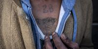A gang member shows off his prison gang tattoos.<br>Photo: Shiraaz Mohamed.