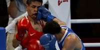 TOKYO, JAPAN - JULY 24: Mohammad Alwadi of Jordan (L) exchanges punches with Ceiber David Avila Segura of Colombia during the Men's Feather (52-57kg) on day one of the Tokyo 2020 Olympic Games at Kokugikan Arena on July 24, 2021 in Tokyo, Japan. (Photo by Buda Mendes/Getty Images)