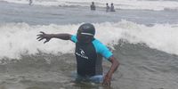 Durban mayor Mxolisi Kaunda takes a dip in the sea on 1 December 2022 in a desperate bid to woo tourists back to the city’s  beaches. (Photo: Tony Carnie)