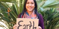 Janisha Harie holds the earth. This was part of a ‘sign of change’ put together by @raisingthemgreen during plastic-free July. (Photo: supplied)