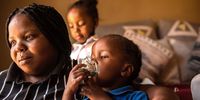 It is a struggle to support two children with severe asthma, says Mbali Mathebula. Her children are immunocompromised, and constantly exposed to high levels of air pollution. Daughter Asemahle, 4, demonstrates how the nebuliser works. (Photo by Alet Pretorius)