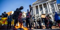 DENVER, CO - JANUARY 20: Members of the Communist Party USA and other anti-fascist groups burn an American flag on the steps of the Colorado State Capitol on January 20, 2021 in Denver, Colorado. Joe Biden was sworn in as the 46th President of the United States with Vice President Kamala Harris at an inauguration ceremony in Washington DC earlier in the day. (Photo by Michael Ciaglo/Getty Images)